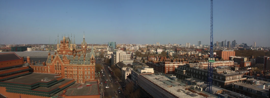 a large city skyline with tall buildings and a crane in the foreground