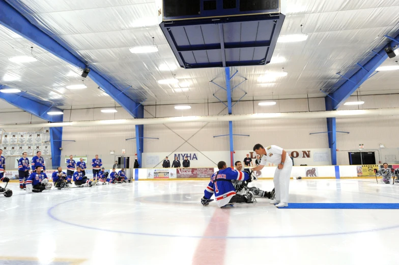 a man holding onto a glove on an ice rink