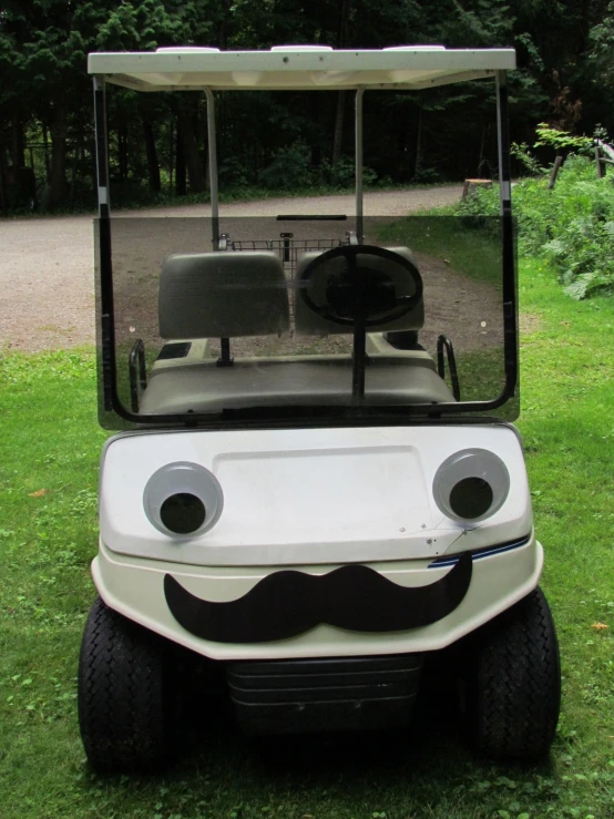 a golf cart with the mouth and moustache on it