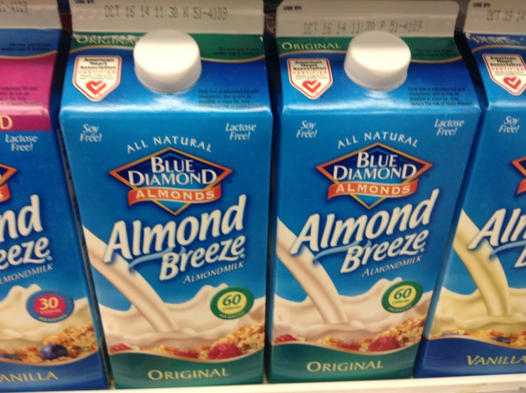 three blue diamond almond milk bottles in a store