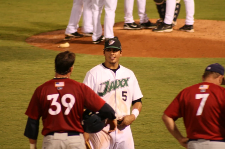 two baseball players congratulate each other on the field