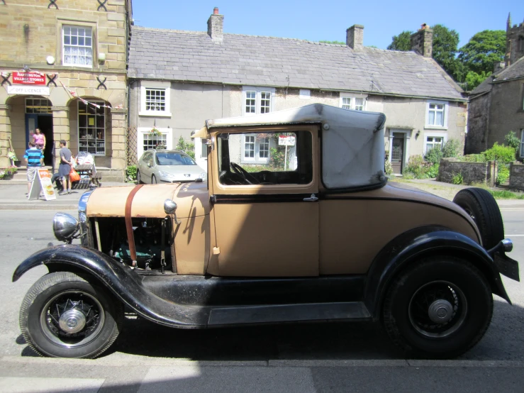 an antique vehicle parked on the street outside