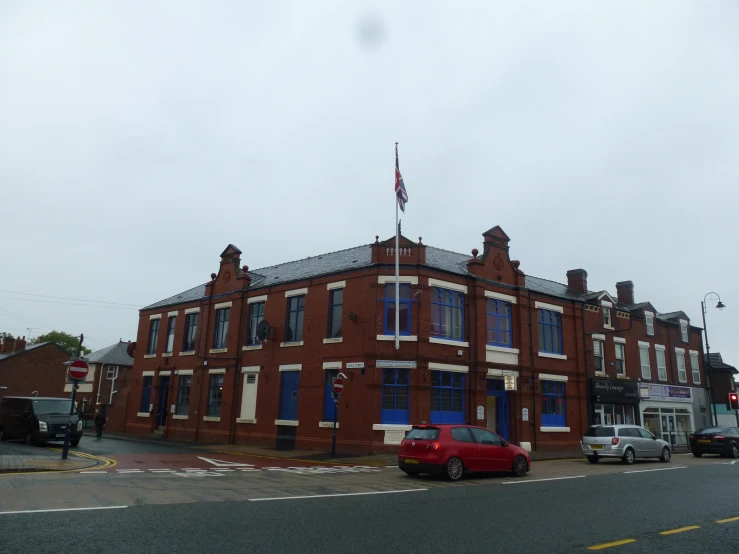 cars parked along side of an old brick building