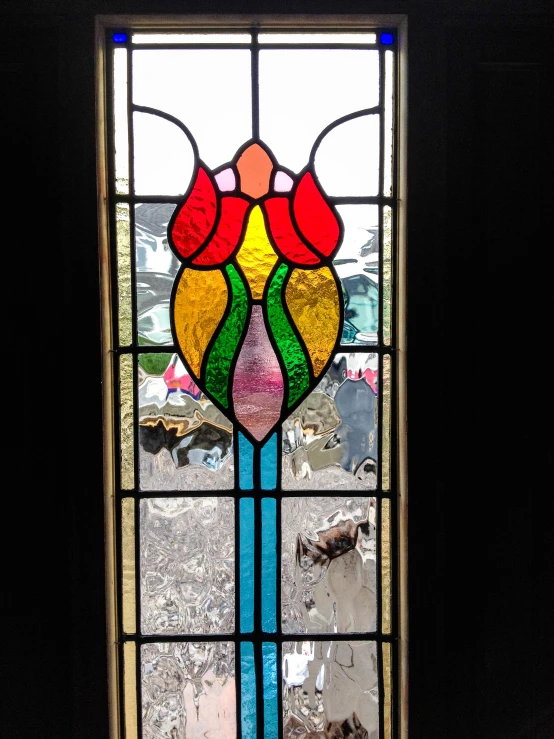 a beautiful stained glass window with flowers inside