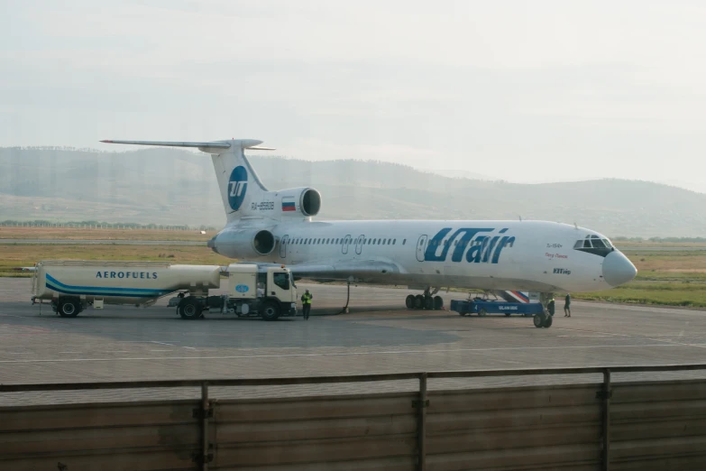 a white jet sitting on top of an airport runway