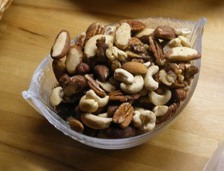 a plastic container filled with lots of nuts on a table