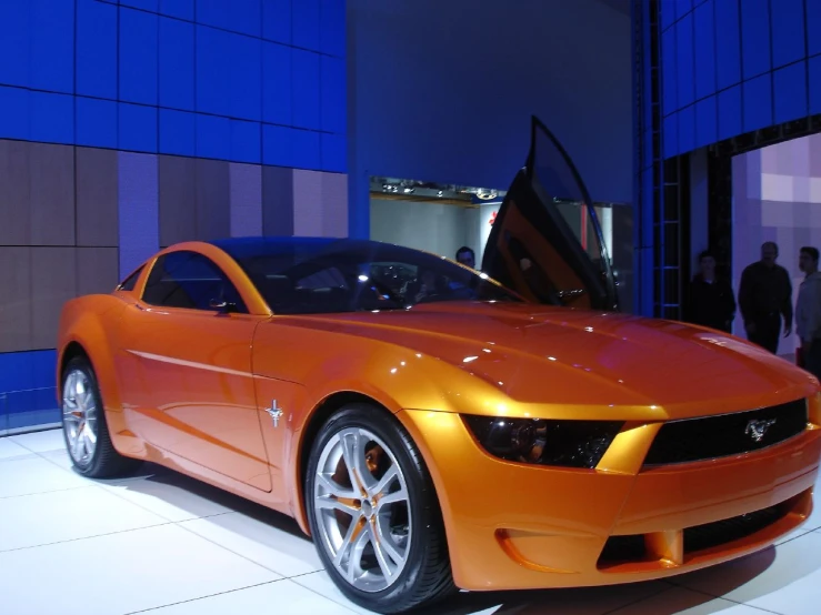 a red car is sitting on display at a show