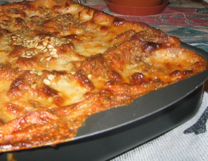 a large square pizza sitting on top of a pan