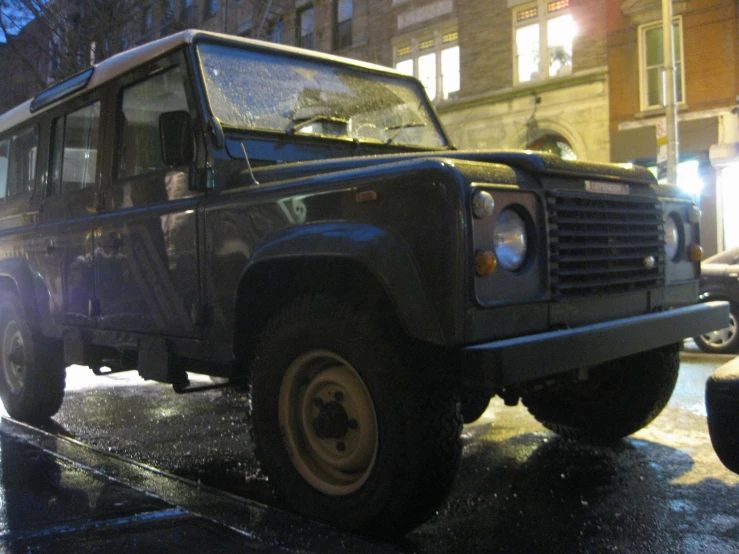 a military style vehicle with a man in the back seat