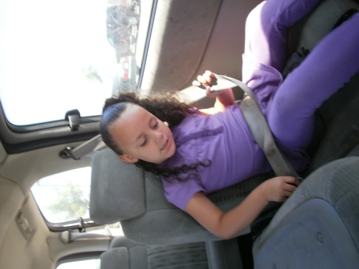 a  sitting in a car seat