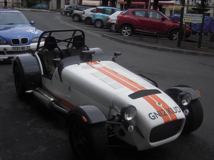 an old race car with stripes on the side