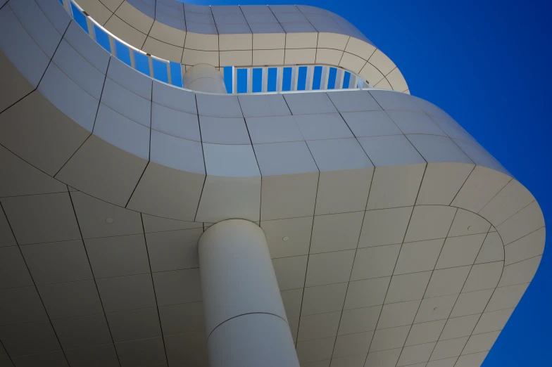 curved architecture with white painted sides against blue sky