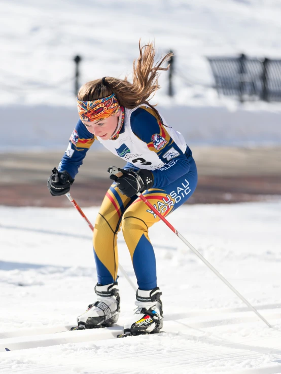 a woman riding skis down a snow covered slope