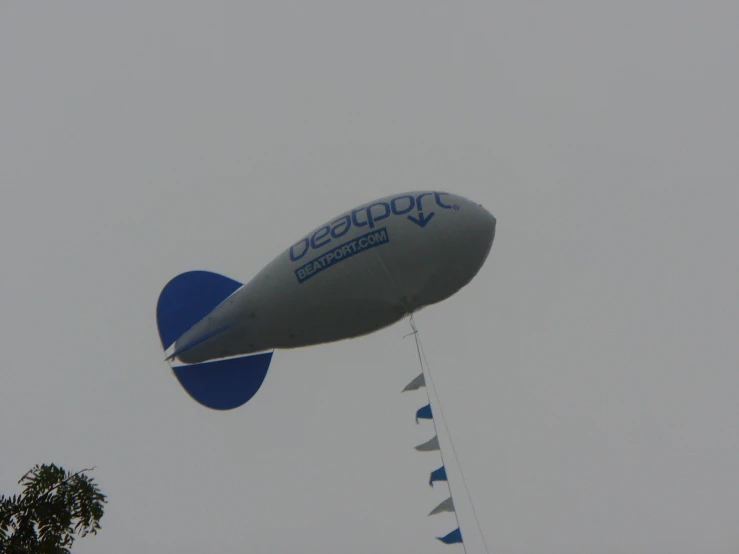 large, inflatable, flying object against gray sky