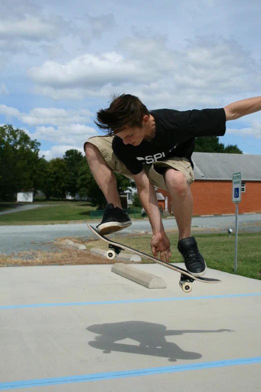 a man in black shirt doing tricks on a skateboard