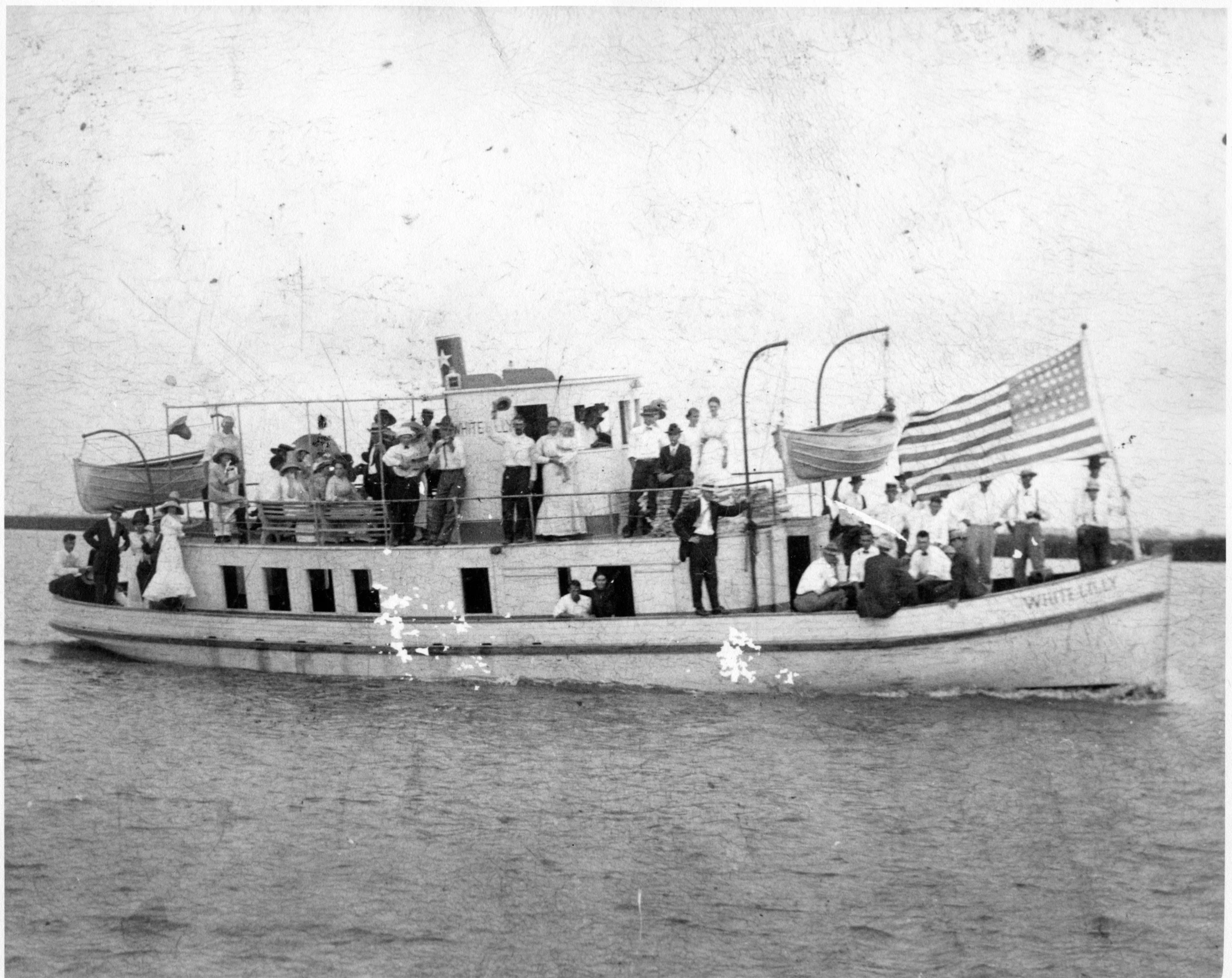 a large boat filled with people sailing on top of water