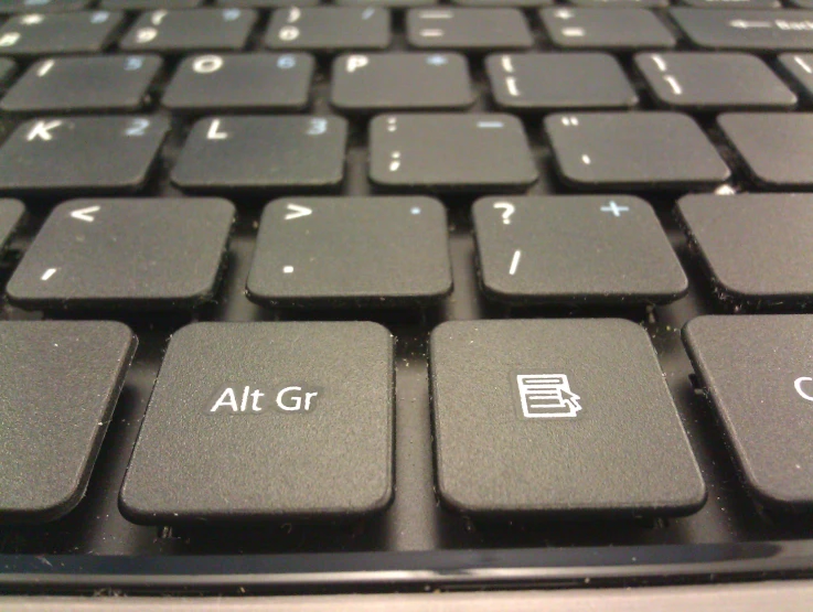 the top half of a computer keyboard with a black keys