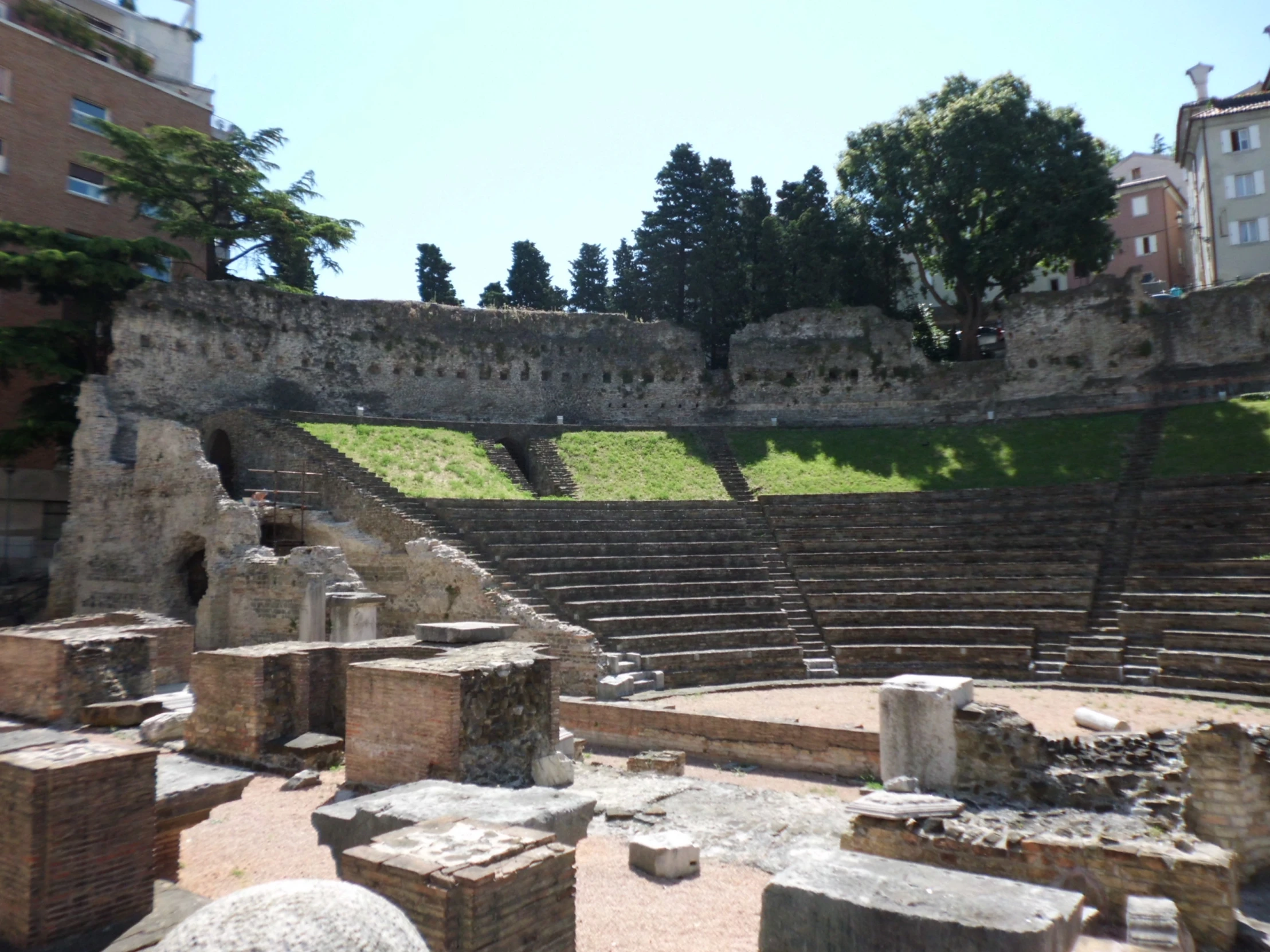 stone blocks are placed next to an old building with a view of the ruins and trees