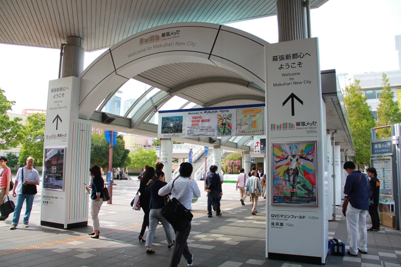 a group of people standing under a train station