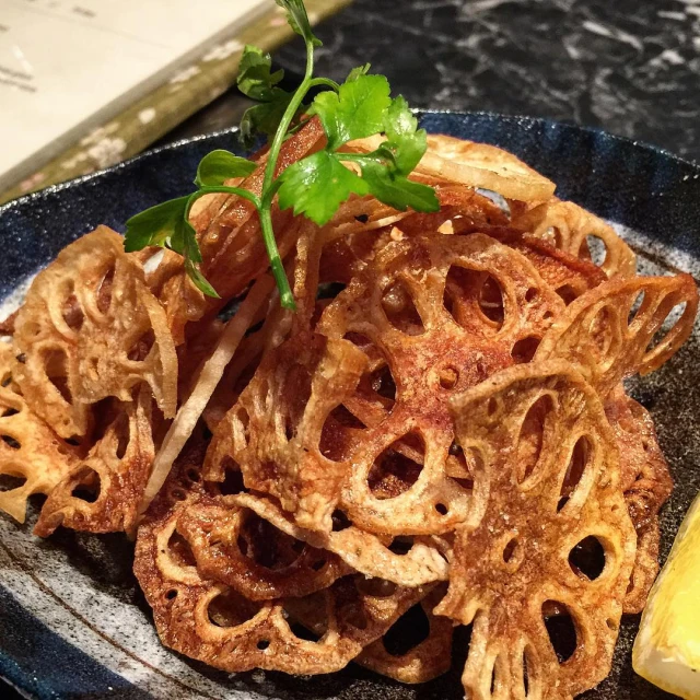 a plate with several cooked snacks sitting on a table