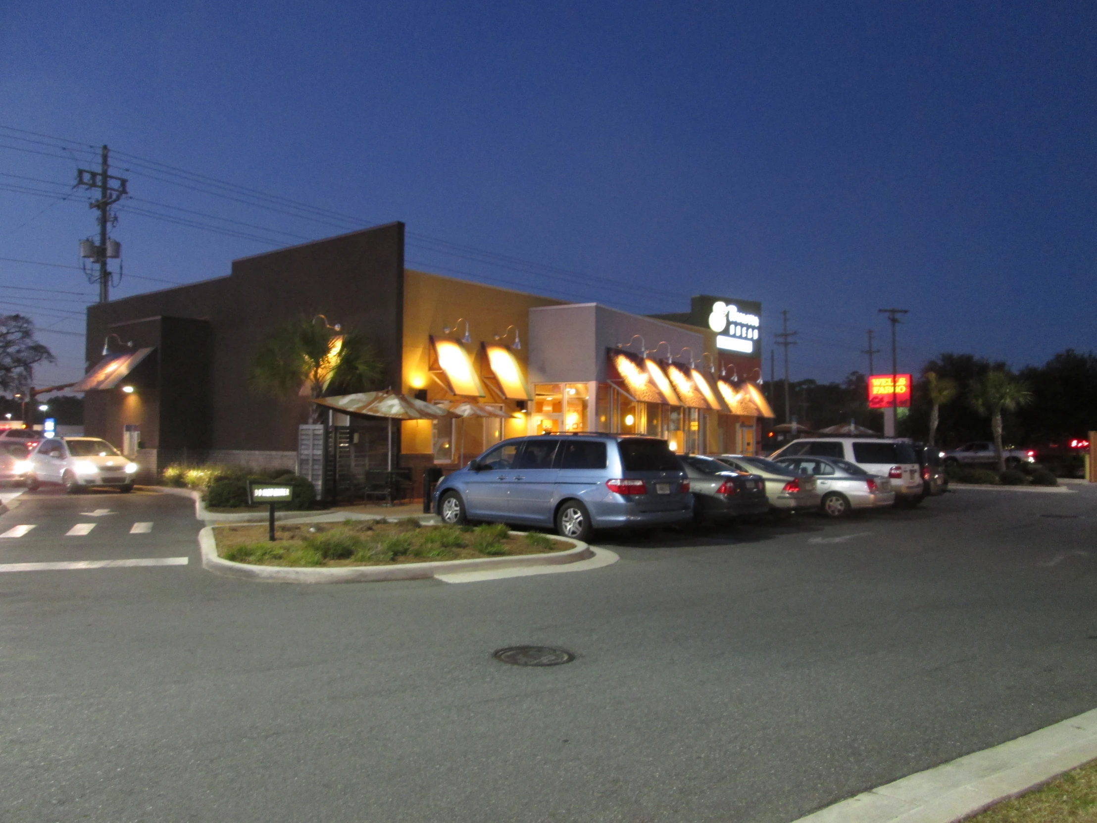 cars lined up on the street waiting to leave the store