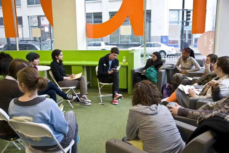 group of people sitting on couches talking together