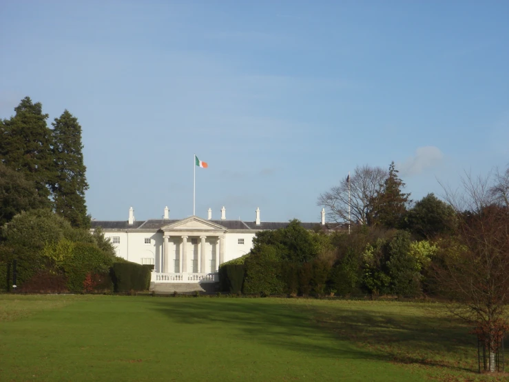 a large building with a tall tower sitting in a park