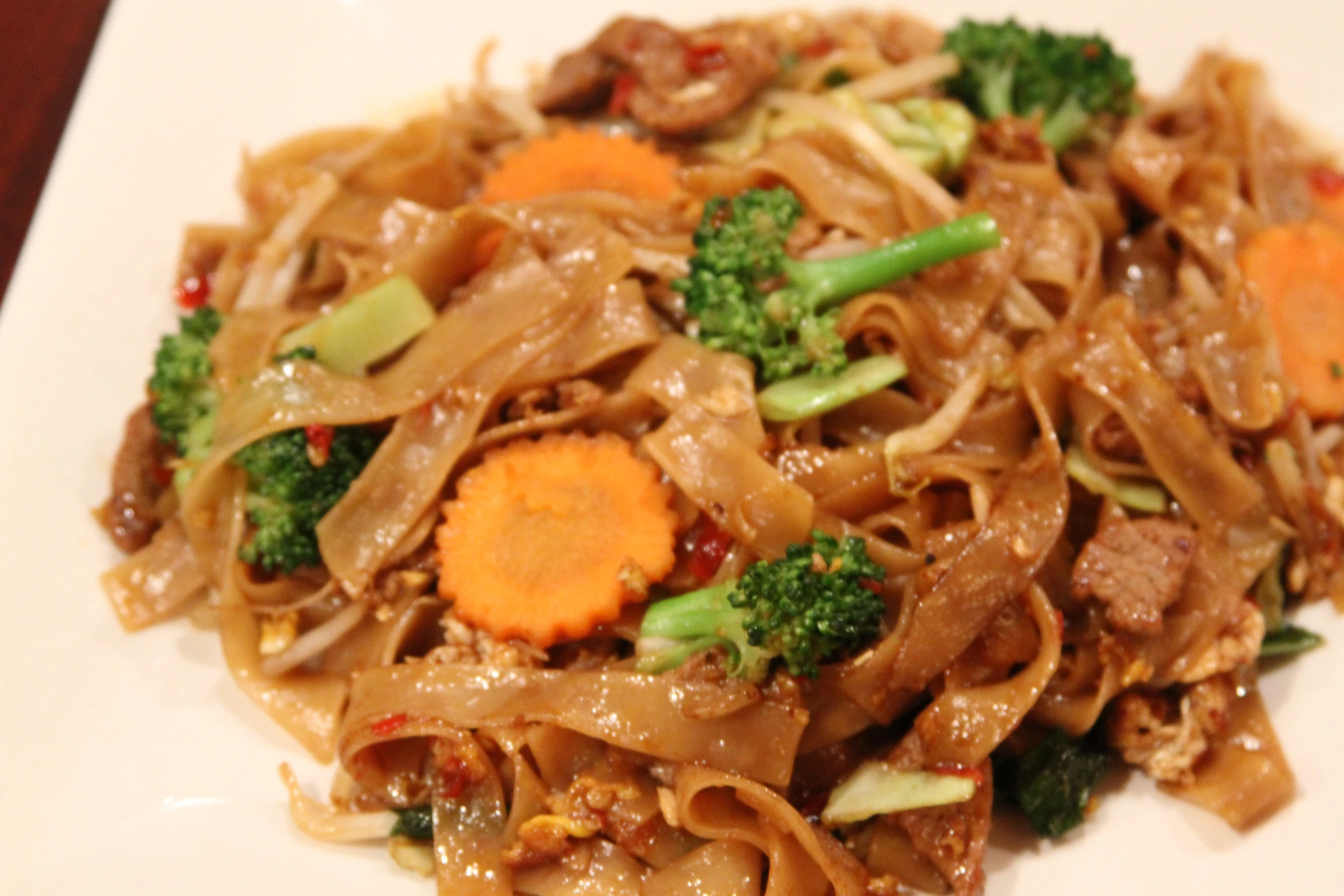 a plate with stir fry, meat and vegetables on it