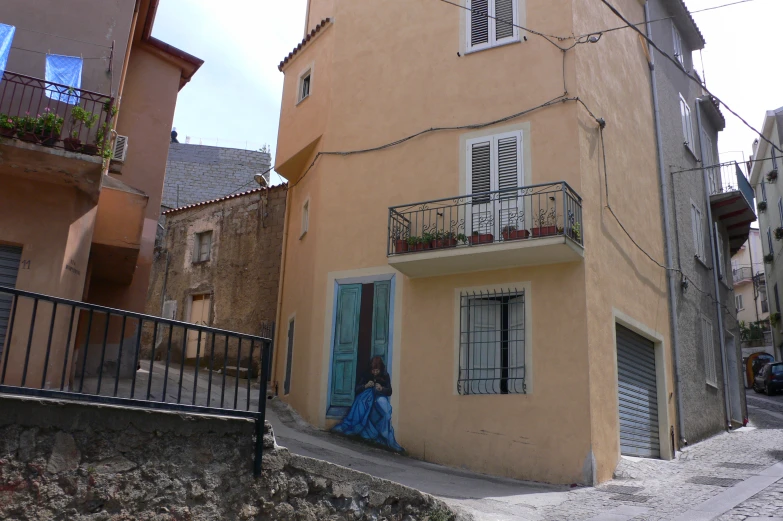 the small building has an open window and balconies