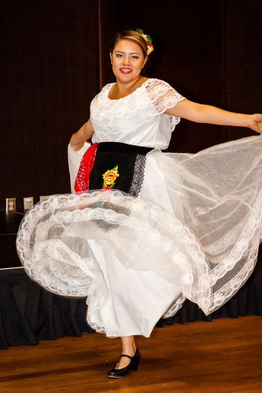 a woman is posing for a picture on the stage