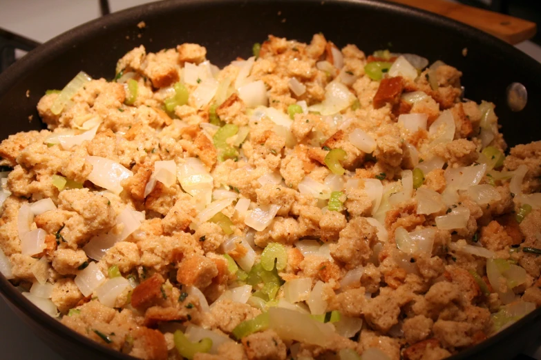 a pan full of stuffing and onions cooking