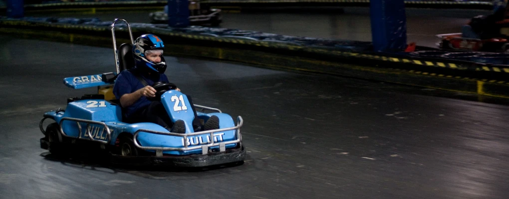 a  riding on the back of an amut park bumper car