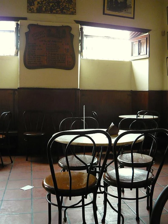 the sun shines through two windows in the dining room