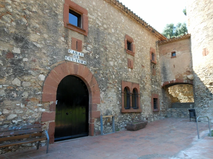 a brick building has two benches by it