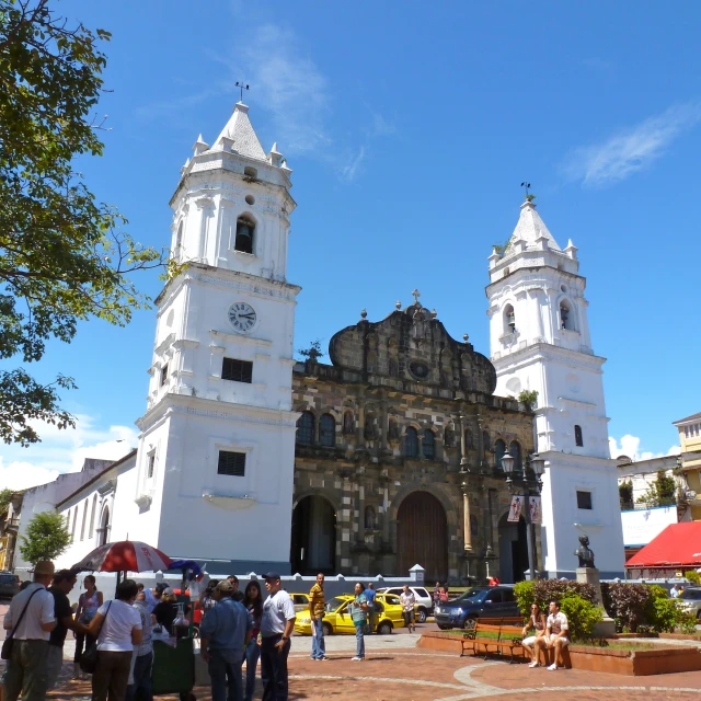 a group of people standing in front of an old church