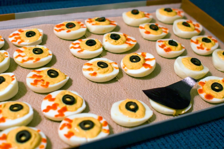 decorated devil cheeses and black eyed peas in tray