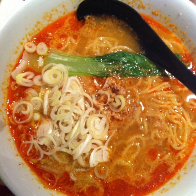 a bowl filled with noodle soup and noodles