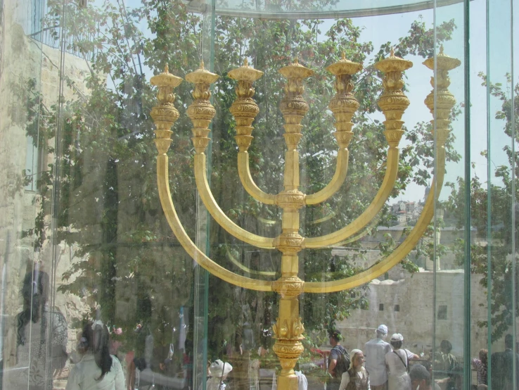 a golden menorah in a mirrored case