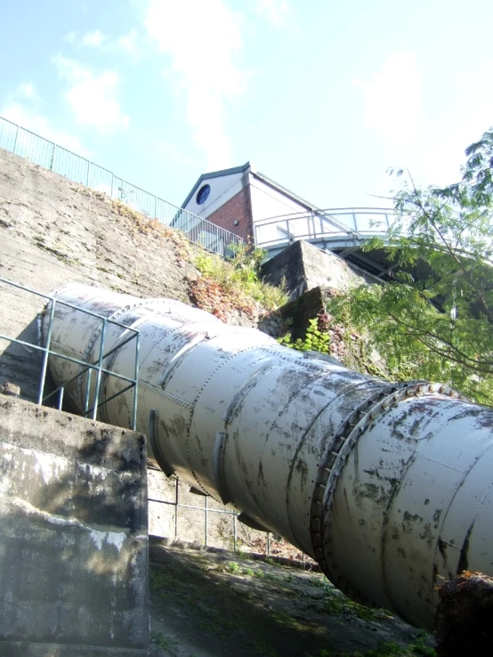 large pipe protruding from the top of a steep hillside