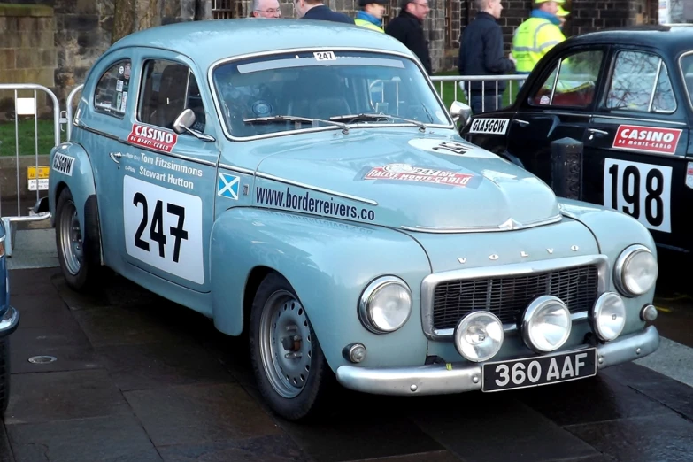 an antique car with stickers on it's side