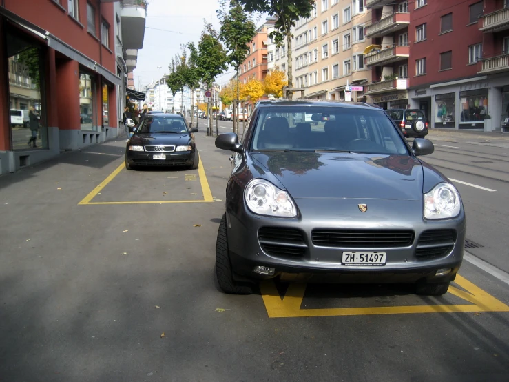 the cars are parked in a city parking lot