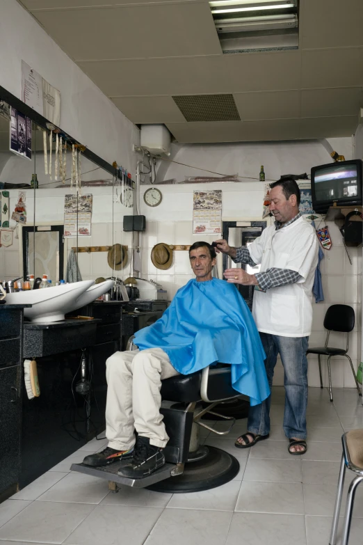 a man in the hair shop getting his hair cut