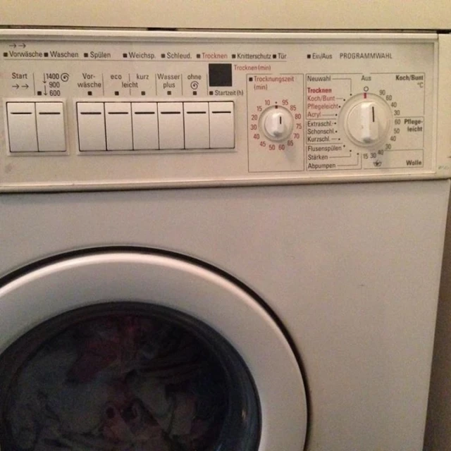 a washer machine with its door open near some s