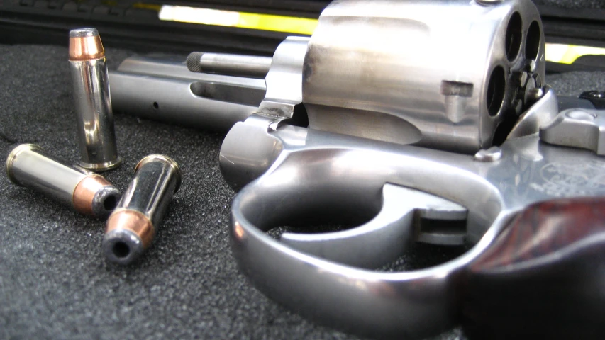 two handguns sitting on top of a table