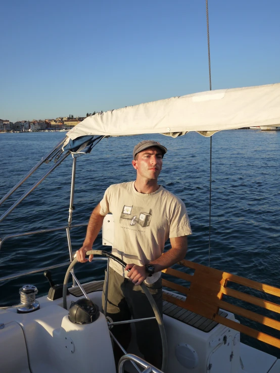 the man on the front deck of a boat is posing for the camera