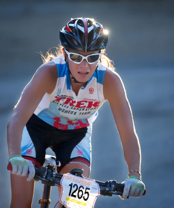 a woman wearing sunglasses while riding a bicycle