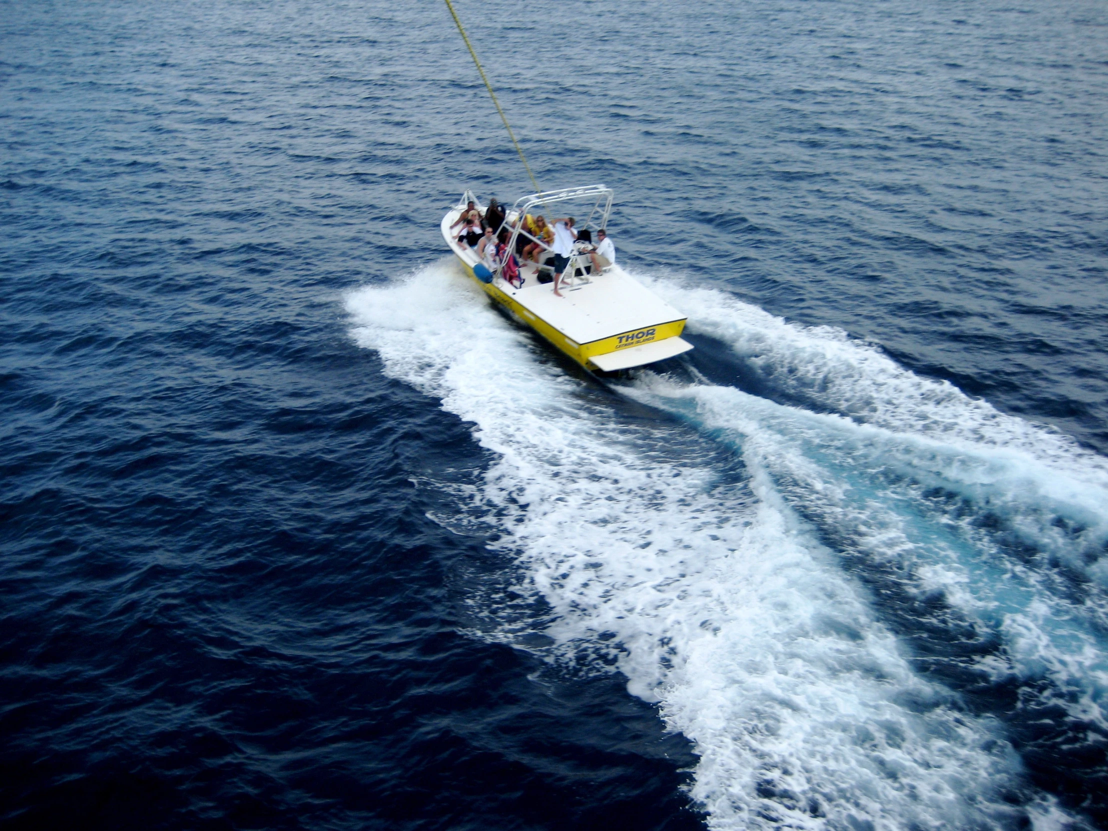 an aerial view of the back of a boat pulling up to a crew