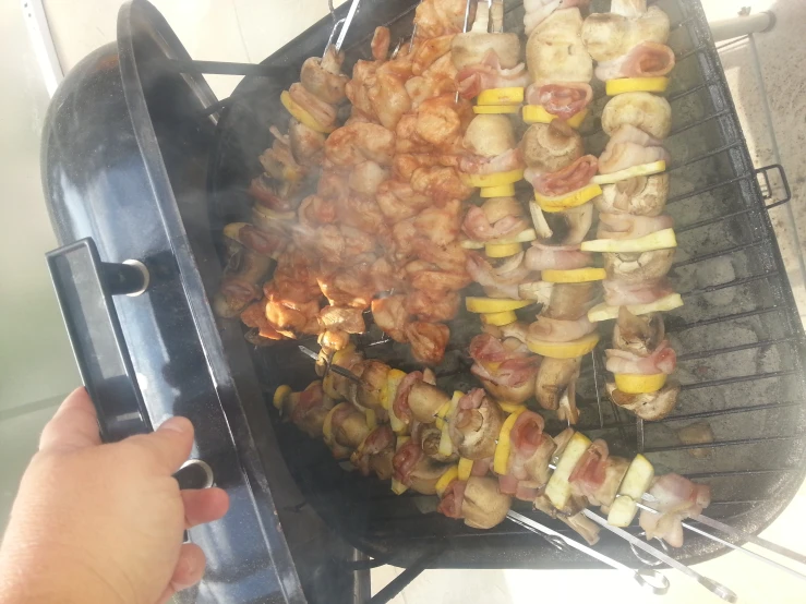 a close up of a person cooking chicken on the grill