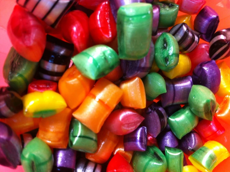 there is many colorful candies in the bowl