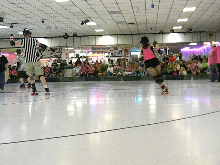 two people doing skate tricks on a hard surface